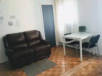 a living room with a couch and a table at Hotel Mini Inc in Montréal