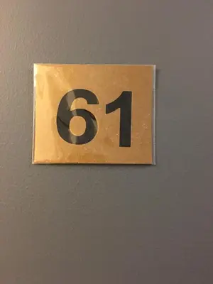 a sign with the number on a wall at Hotel Mini Inc in Montréal