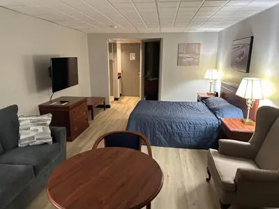 a hotel room with a bed and a table at Hôtel Motel Le Voyageur in Saint-Georges