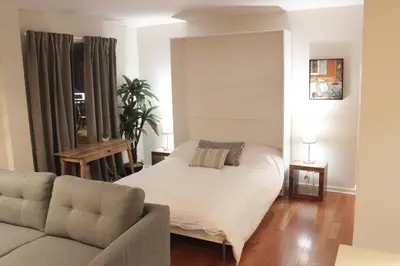 a bedroom with a bed and a couch at Suite Mont-Royal by MTLVacationRentals in Montréal