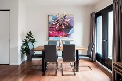 a dining room with a wooden table and chairs at Suite Mont-Royal by MTLVacationRentals in Montréal