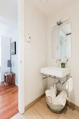 a bathroom with a sink and a basket at Suite Mont-Royal by MTLVacationRentals in Montréal