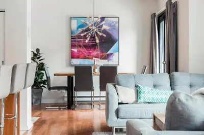a living room with a blue couch and a table at Suite Mont-Royal by MTLVacationRentals in Montréal