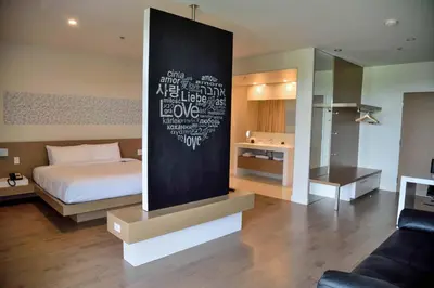 a bedroom with a bed and a wall with words at Hotel du Lac Champlain in Venise-en-Québec