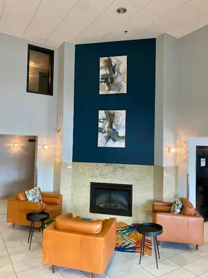 a lobby with two couches and a fireplace at Super 8 by Wyndham Lachenaie/Terrebonne in Terrebonne