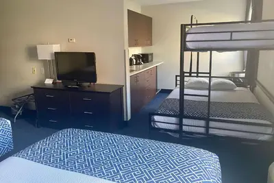 a bedroom with a bunk bed and a television at Super 8 by Wyndham Lachenaie/Terrebonne in Terrebonne
