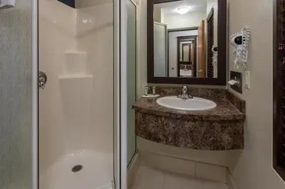 a bathroom with a sink and a shower at Super 8 by Wyndham Lachenaie/Terrebonne in Terrebonne