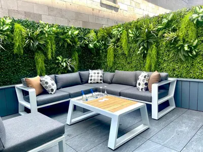 a patio with a couch and a table and chairs at Le Mount Stephen in Montréal