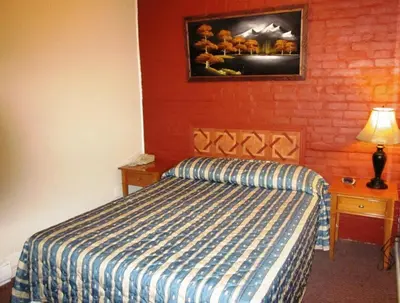 a bedroom with a bed and a painting on the wall at Hotel Ste-Catherine in Montréal