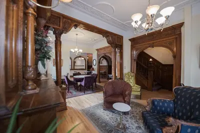 a living room with a table and chairs at Manoir Sherbrooke in Montréal