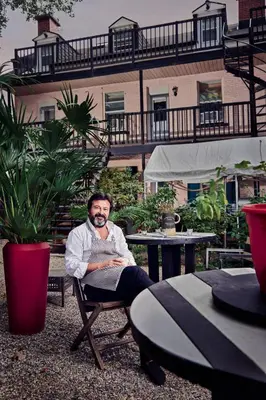 a man sitting in a chair in front of a building at L'Hotel Particulier Griffintown in Montréal