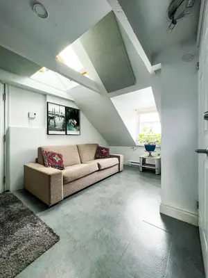 a living room with a couch and a window at L'Hotel Particulier Griffintown in Montréal