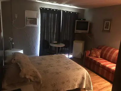 a living room with a couch and a table at Motel la Siesta de Gascon in Terrebonne