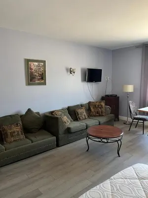 a living room with a couch and a table at Motel la Siesta de Gascon in Terrebonne