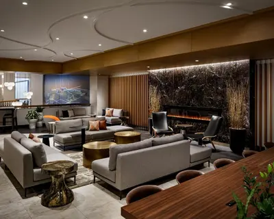 a lobby with couches and chairs and a fireplace at Montreal Marriott Chateau Champlain in Montréal