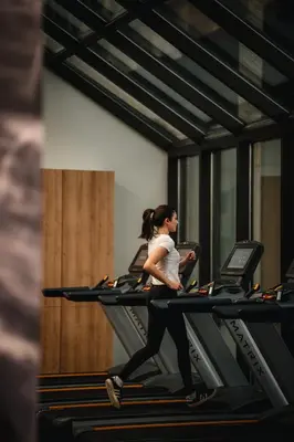 a woman running on a treadmill in a gym at Montreal Marriott Chateau Champlain in Montréal