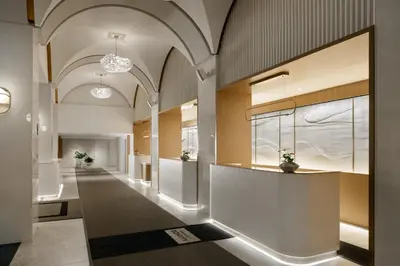 a hallway of a building with a reception desk in the middle at Montreal Marriott Chateau Champlain in Montréal