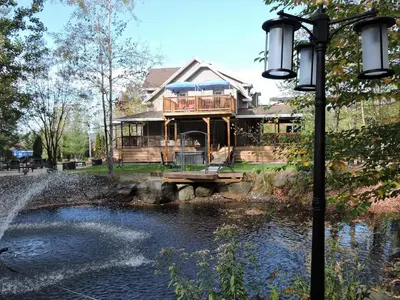 a house sitting on top of a river with a street light at Gite Passion et Tendresse B&B in Shefford