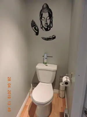 a bathroom with a toilet with a football decal on the wall at Gite Passion et Tendresse B&B in Shefford