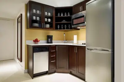 a kitchen with wooden cabinets and a refrigerator at Residence Inn by Marriott Montréal Downtown in Montréal