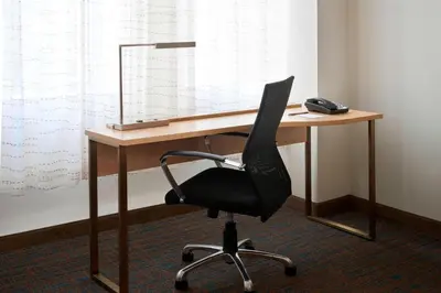 a desk with a chair and a mirror on it at Residence Inn by Marriott Montréal Downtown in Montréal