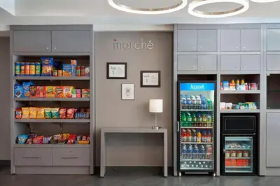 a store with a refrigerator and shelves of food at Residence Inn by Marriott Montréal Downtown in Montréal