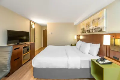 a hotel room with a large bed and a flat screen tv at Comfort Inn South Shore in Boucherville