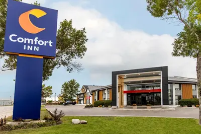 a sign for a comfort inn in front of a building at Comfort Inn South Shore in Boucherville