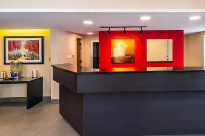 a bar in a room with a red wall at Comfort Inn South Shore in Boucherville
