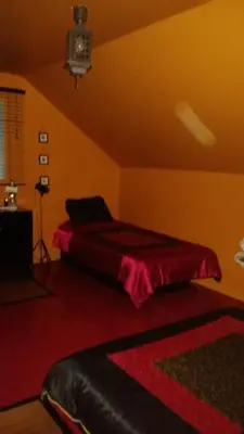 a bedroom with a bed with a red blanket on it at Gite Agricole Les Lilas in Saint Wenceslas