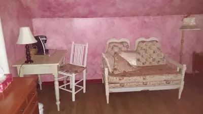 a bedroom with a bed and a desk and a chair at Gite Agricole Les Lilas in Saint Wenceslas