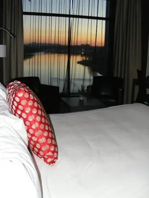 a bedroom with a bed with polka dot pillows on it at Grand Hotel Times Sherbrooke in Sherbrooke