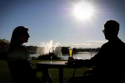 a man and woman sitting at a table with a glass of wine at Grand Hotel Times Sherbrooke in Sherbrooke