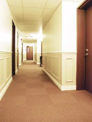 an empty hallway in an office building with a corridor at Auberge du Grand Lac in Magog-Orford