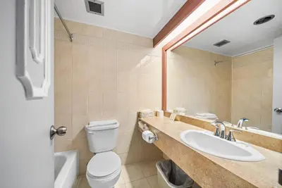 a bathroom with a toilet and a sink at Hotel-Motel Coconut in Trois-Rivières