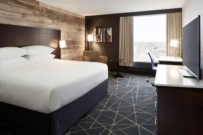 a hotel room with a bed and a desk at Delta Hotels by Marriott Sherbrooke Conference Centre in Sherbrooke