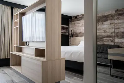 a bedroom with a bed and a sliding glass door at Delta Hotels by Marriott Sherbrooke Conference Centre in Sherbrooke
