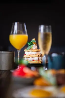 a table with two glasses of wine and a plate of food at Delta Hotels by Marriott Sherbrooke Conference Centre in Sherbrooke