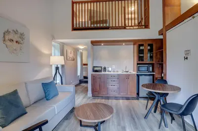 a living room with a couch and a table at Estrimont in Magog-Orford