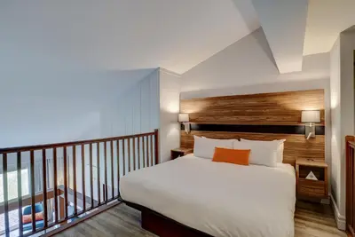 a bedroom with a bed and a balcony at Estrimont in Magog-Orford