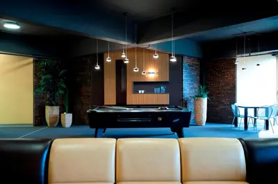 a living room with a pool table and chairs at ZUM MTL Auberge d'été - Université de Montréal in Montréal