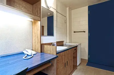 a bathroom with a blue counter and a sink at ZUM MTL Auberge d'été - Université de Montréal in Montréal