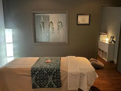 a bedroom with a bed and a window with flowers at Hotel & Suites Le Dauphin Drummondville in Drummondville