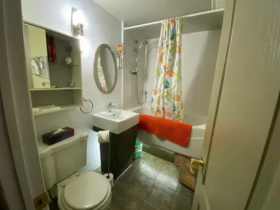 a small bathroom with a toilet and a sink at Martine & Michel in Boucherville