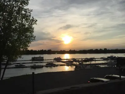 a sunset over a marina with boats in the water at Martine & Michel in Boucherville