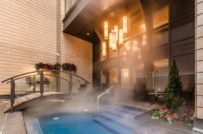 a swimming pool in the lobby of a hotel at Metcalfe Hotel Montréal by Gray Collection in Montréal