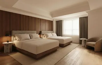 a bedroom with two beds and a chair and a window at Metcalfe Hotel Montréal by Gray Collection in Montréal