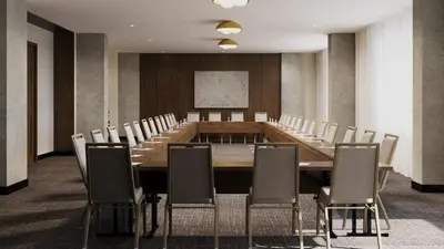 a conference room with a long table and chairs at Metcalfe Hotel Montréal by Gray Collection in Montréal