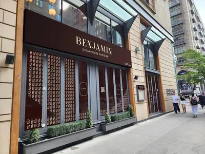 a store front of a building with people walking past it at Metcalfe Hotel Montréal by Gray Collection in Montréal