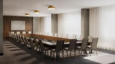 a conference room with a long table and chairs at Metcalfe Hotel Montréal by Gray Collection in Montréal